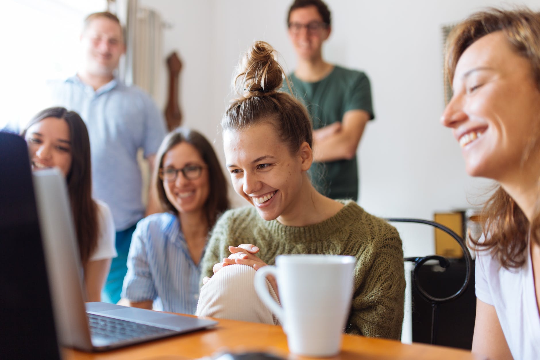 group of people watching gray laptop computer